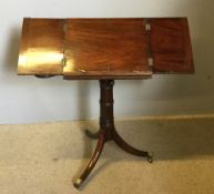 A George III mahogany music stand The twin hinged adjustable top above two fold-out candle stands,