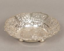 A Chinese silver bowl Of pierced form, with various animal and floral filled vignettes,