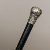 A 19th century unmarked white metal handled ebony walking stick The knop handle embossed with