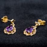 A pair of 9 ct gold amethyst set earrings Each of drop form. Each 1.7 cm high.