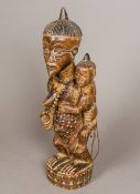 A large African tribal carved wooden figural group Formed as a female figure holding a child on her