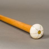 A 19th century ivory handled walking stick The squat knop with brass pique inlaid decoration,