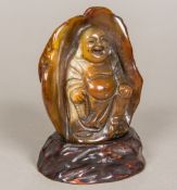 A Chinese agate bolder carving Formed as Buddha holding a chain, mounted on a wooden plinth base.