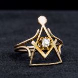 An unmarked gold diamond set ring Worked with Masonic emblems. 2.2 cm high.