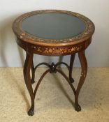 An Edwardian inlaid mahogany bijouterie table The hinged double glazed circular top with a border