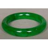A Chinese carved spinach jade bangle 8.5 cm diameter.