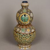 A 19th century Oriental, possibly Korean, reticulated pottery vase Of double gourd form,