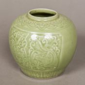 A Chinese celadon ground ginger jar Decorated with twin panels of dragons chasing a flaming pearl.