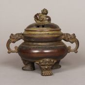 A Chinese patinated bronze censer The pierced removable lid with an elephant form finial,