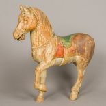 A late 19th century carved wooden horse Typically modelled with iron bit and painted details.