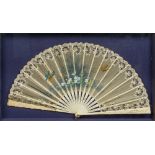 A late 19th century Continental decorated and lace worked bone fan The staves pierced and carved,