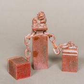 A set of three Chinese carved soapstone seals The central seal carved with a dog-of-fo finial above