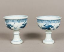 A pair of Chinese blue and white porcelain stem cups Both figurally decorated,