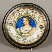 An Italian faience dish Centred with a female figure wearing a jewelled earring and laurel wreath,
