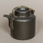A Japanese black basalt teapot Of simple cylindrical form with twin loop handle and removable lid.