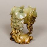 A Chinese carved jade brush washer The shaped bowl supported on tree form legs. 10.5 cm high.