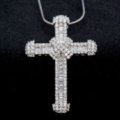 An 18 ct white gold diamond set crucifix Set with round and baguette cut diamonds,