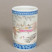 A Chinese porcelain brush pot Worked with figures in a continuous snowy landscape opposing