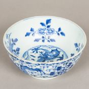 A Chinese blue and white porcelain bowl Worked with dragons amongst stylised clouds,