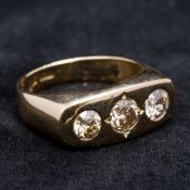 A 18 ct gold diamond three stone ring Gypsy set, the central stone spreading to approximately 0.