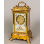 A 19th century French lacquered brass cased musical four glass mantel clock The brass dial with
