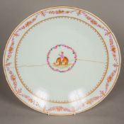 An 18th century Chinese Export charger Of dished form with puce and gilt trailing foliate swag