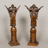 A pair of 18th/19th century Continental carved and stained softwood figures of angels Both worked