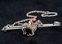A unmarked gold diamond, ruby and enamel bar brooch Worked as a horse and jockey,