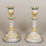 A pair of enamel decorated silver and rock crystal candlesticks Each with removable drip-pan above