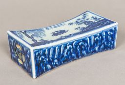 A Chinese blue and white porcelain wrist wrest Of concave rectangular form with pierced ends worked