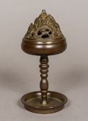 A Chinese patinated bronze censer The pierced removable lid formed as a mountain and with mythical