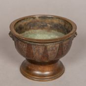 An archaistic style Chinese patinated bronze censer Of waisted footed circular form,