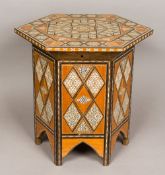 A North African inlaid coffee table The geometrically inlaid hinged hexagonal top enclosing the