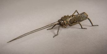 A patinated bronze articulated locust