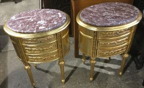 A pair of gilt marble top bedside drawers