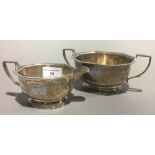 A silver cream jug and sugar bowl,