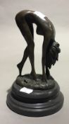 An erotic bronze figure of a bent over nude