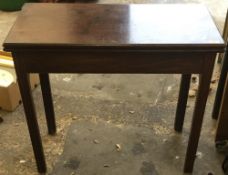 A George III mahogany fold over tea table