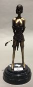 A bronze figure of a female dominatrix