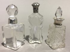 Three Victorian silver mounted cut glass scent bottles