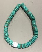 A string of turquoise roundels