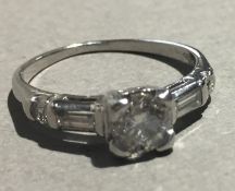 A 22 ct white gold diamond set ring, the central stone spreading to approximately 0.