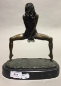 An erotic bronze figure of a spread-legged female