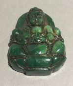 A jade pendant carved as Buddha
