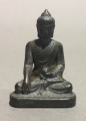A small bronze model of Buddha