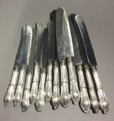 A set of six 800 silver butter knives and six matching table knives