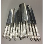 A set of six 800 silver butter knives and six matching table knives