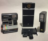 Two polaroid cameras and a flash