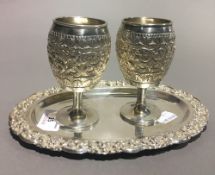 An Eastern silver tray and two cups