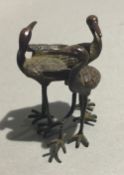 A Chinese bronze model of three storks